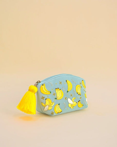 Blue fabric pouch with embroidered bananas and bright yellow tassel zipper, handmade cosmetic and accessory bag.