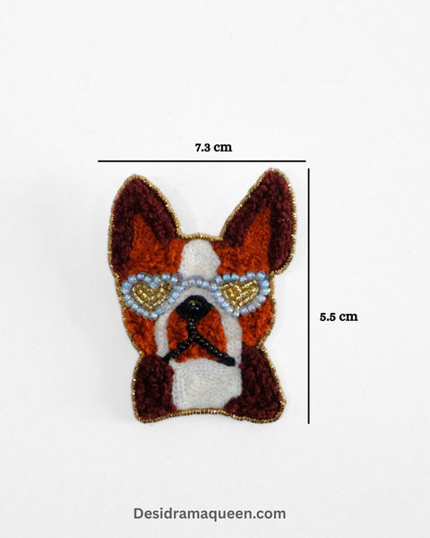 Brown and white embroidered dog brooch with sunglasses design