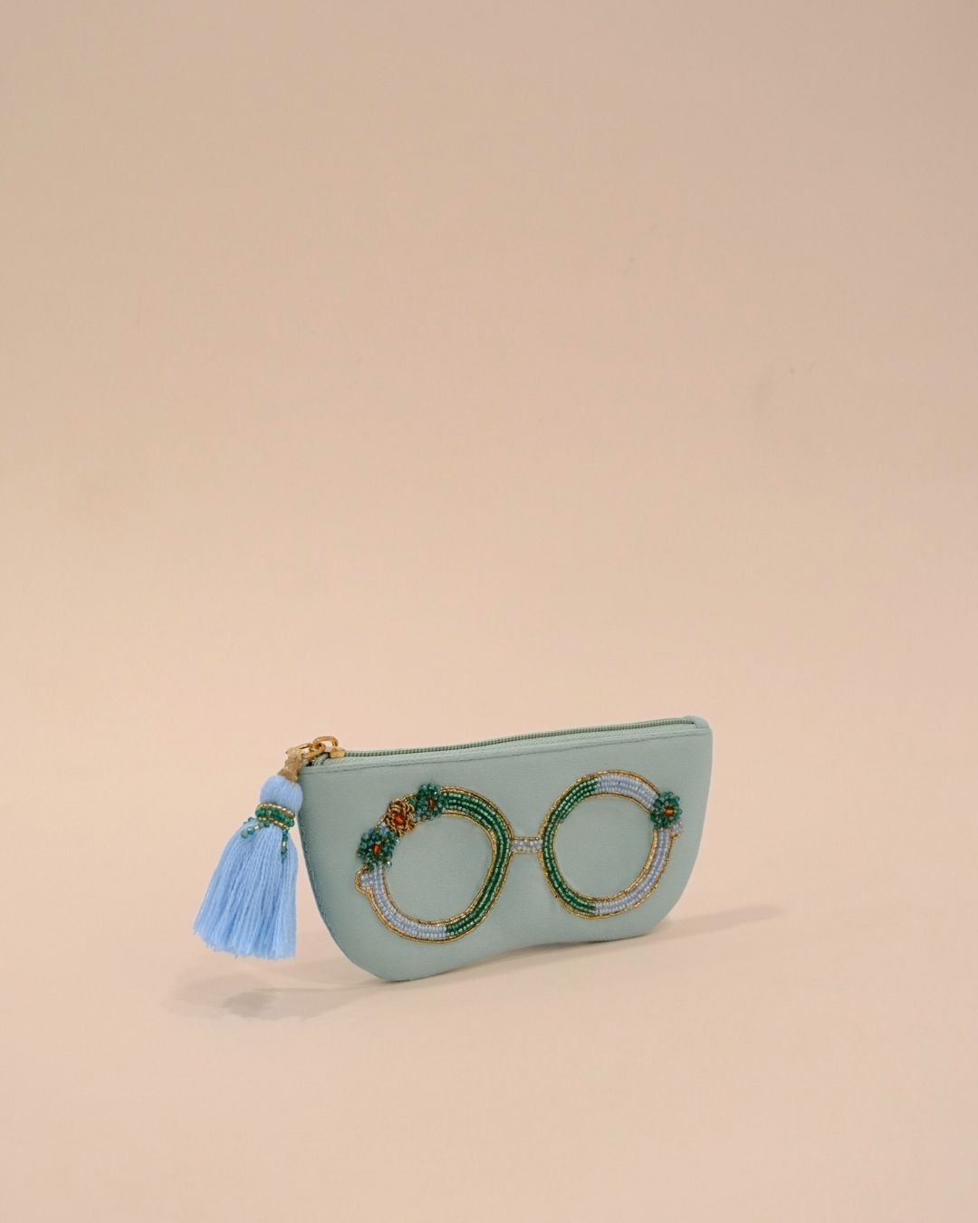 Mint green sunglass case with detailed bead embroidery in green, gold, and blue, handmade eyewear pouch with tassel detail.