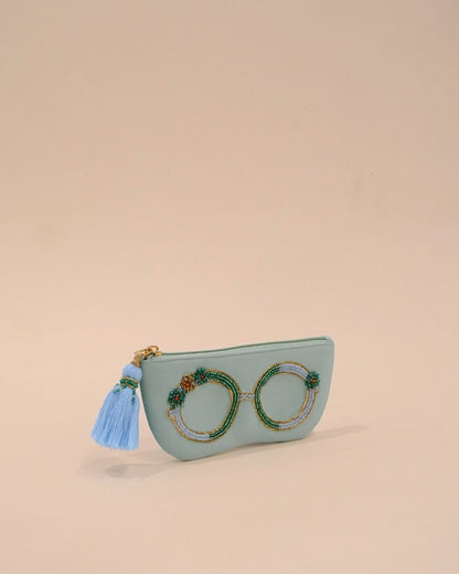 Mint green sunglass case with detailed bead embroidery in green, gold, and blue, handmade eyewear pouch with tassel detail.