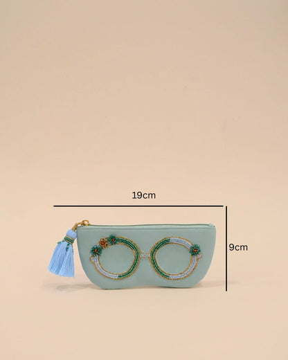 Light blue sunglass cover with intricate bead embroidery of glasses and a tassel zip closure, handmade protective eyewear pouch