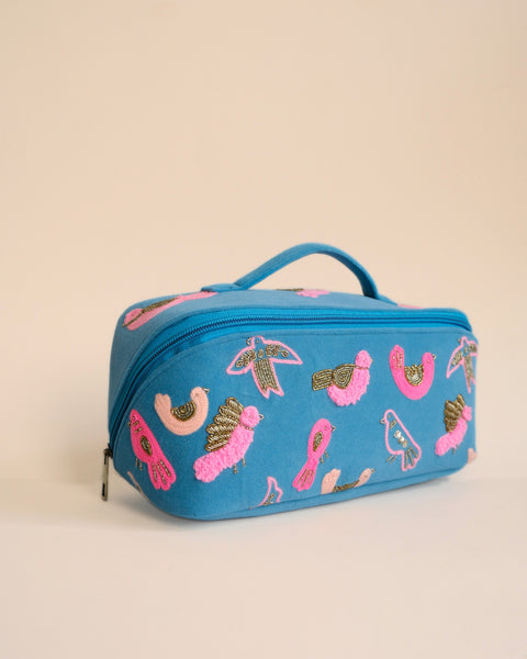 Elegant makeup pouch with bird embroidery, ideal for everyday use and travel storage.
