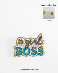 Handmade beaded brooch with #GirlBoss design in gold embroidery and turquoise lettering.
