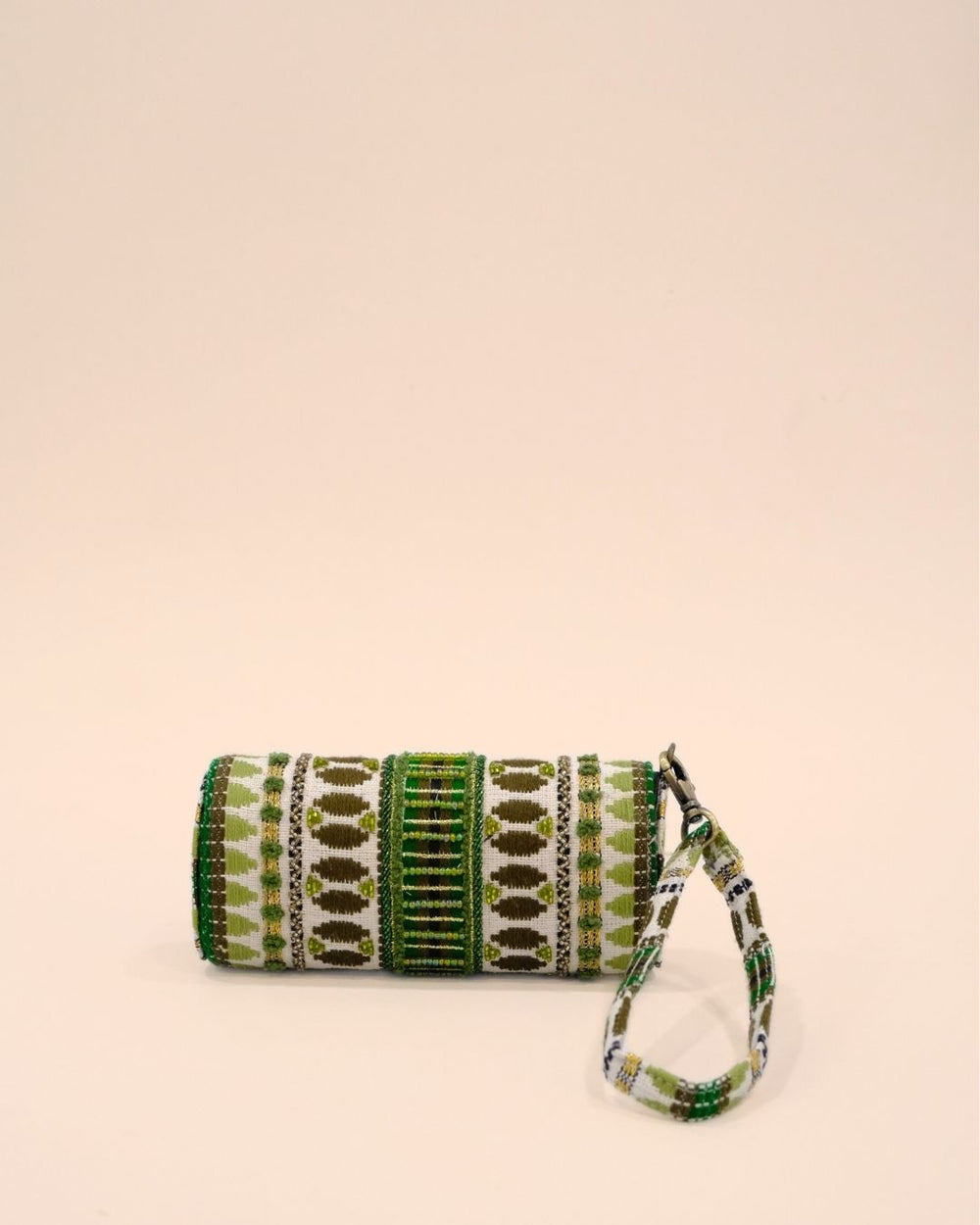 Handmade sunglass cover with tribal embroidery in green, olive, and gold on white base, featuring a matching wrist strap.