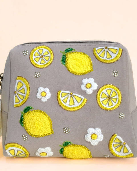 Grey pouch featuring embroidered yellow lemons and white flowers with yellow tassel zipper, handmade cosmetic bag.