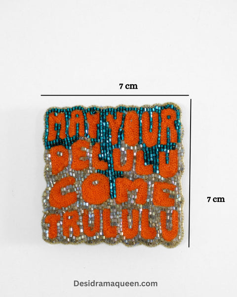 Quirky embroidered brooch with text “May Your Delulu Come Trululu” in colorful beads, handmade statement lapel pin for jackets and bags
