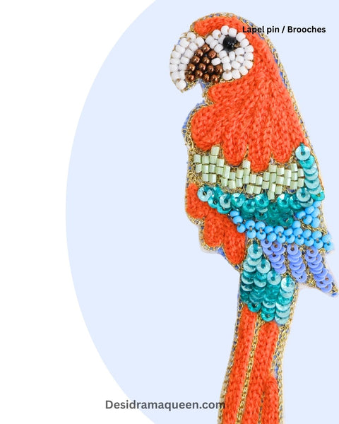 Handcrafted parrot brooch with orange, turquoise, blue, and white bead embroidery, unique handmade lapel pin for jackets and bags.