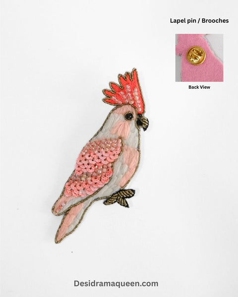 Handmade pink cockatoo bird brooch with sequins and bead embroidery, unique lapel pin accessory.