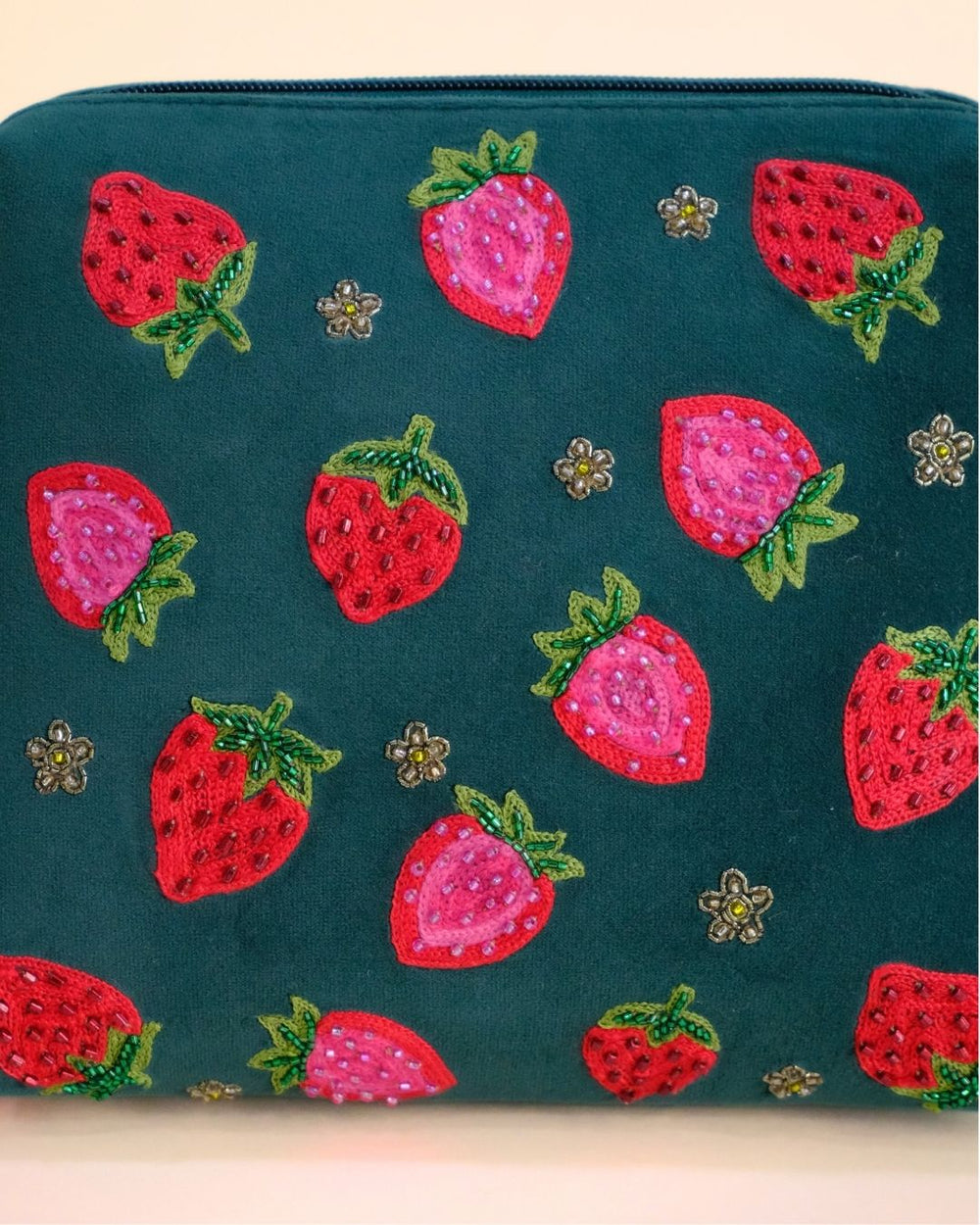 Green makeup pouch with embroidered strawberries and hot pink tassel zipper, handmade cosmetic bag for daily use.