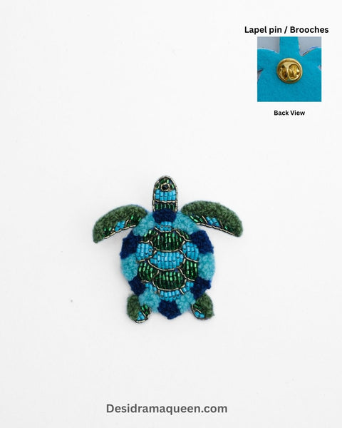 Handmade turtle brooch with blue and green bead embroidery, sea-inspired lapel pin for jackets and bags.