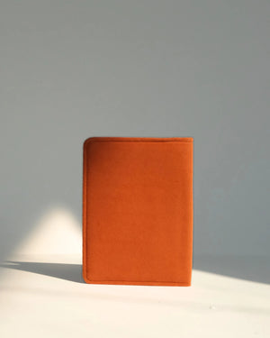 Orange notebook on a gray background