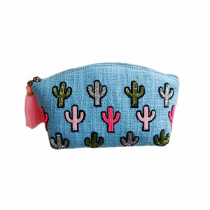 Blue pouch with embroidered cactus designs and tassels on a white background