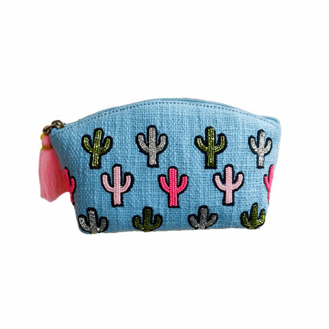 Blue pouch with embroidered cactus designs and tassels on a white background