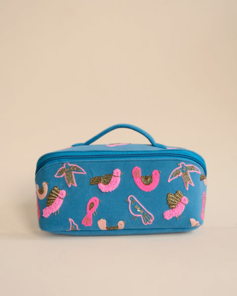 Alt Text: Handmade blue makeup pouch with pink and golden bird embroidery, stylish travel toiletry bag.
