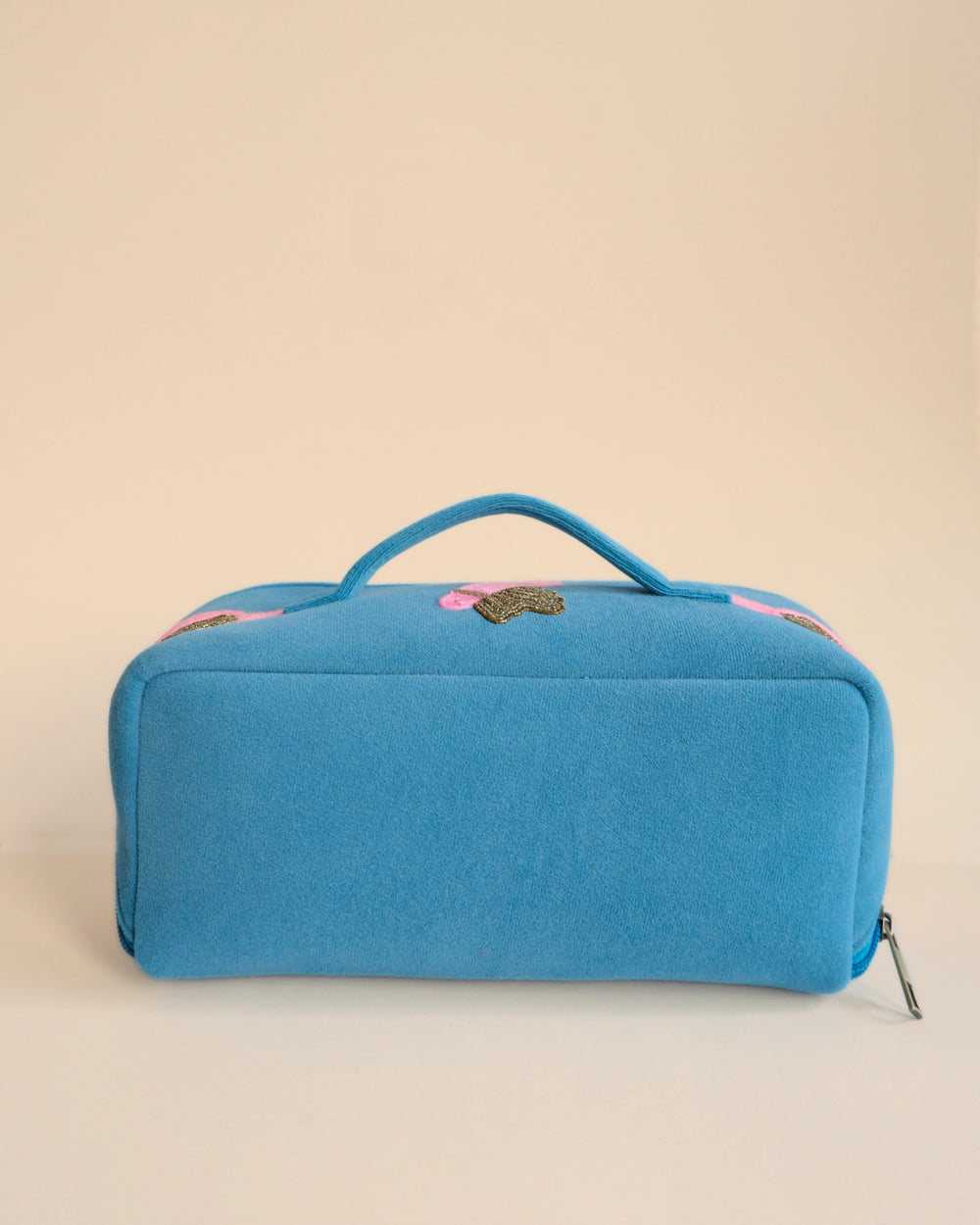 Alt Text: Handmade blue makeup pouch with pink and golden bird embroidery, stylish travel toiletry bag.