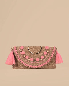 Clutch bag with pink pom-poms and tassels on a beige background