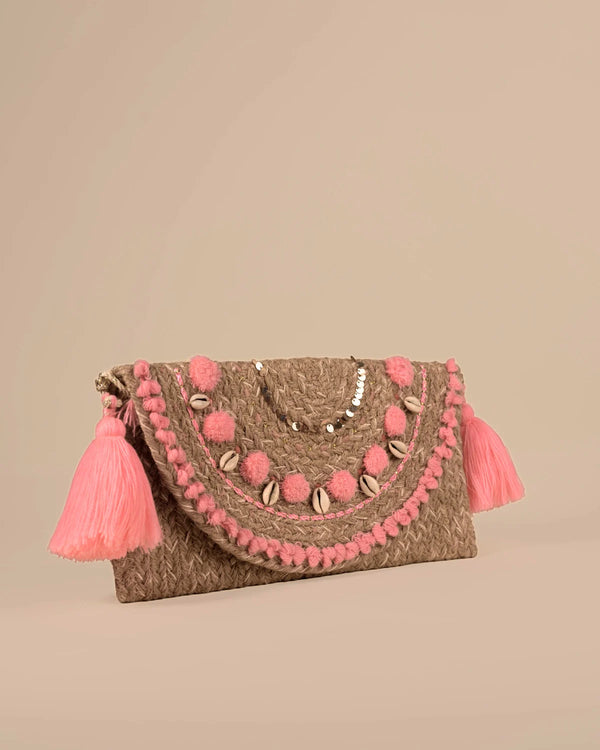 Clutch bag with pink pom-poms and tassels on a beige background