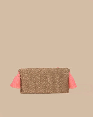 Woven clutch with pink tassels on a beige background
