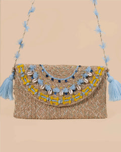 Woven handbag with decorative elements on a beige background