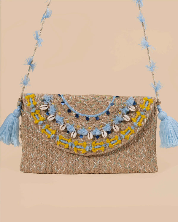 Woven handbag with decorative elements on a beige background