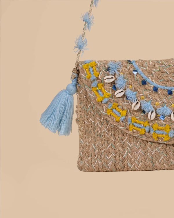 Woven handbag with decorative elements on a beige background