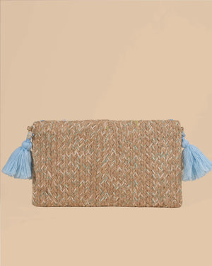Woven clutch bag with blue tassels on a beige background