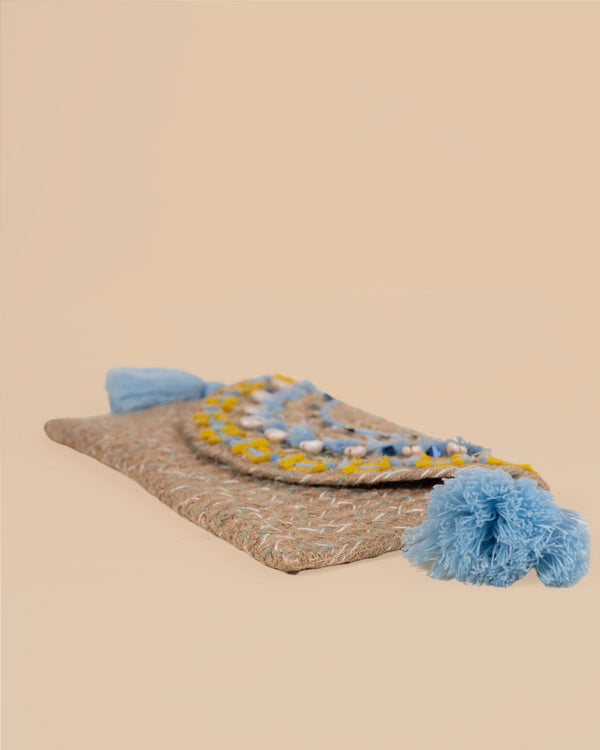 Textile item with pom-poms on a beige background
