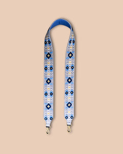 Patterned strap with blue and white design on a beige background