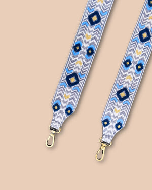 Decorative bag strap with blue floral pattern on a beige background
