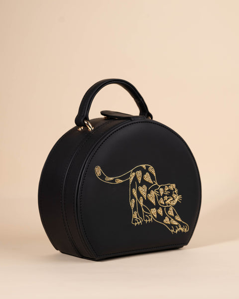 Sophisticated sling bag with hand-embroidered leopard beadwork and short handle