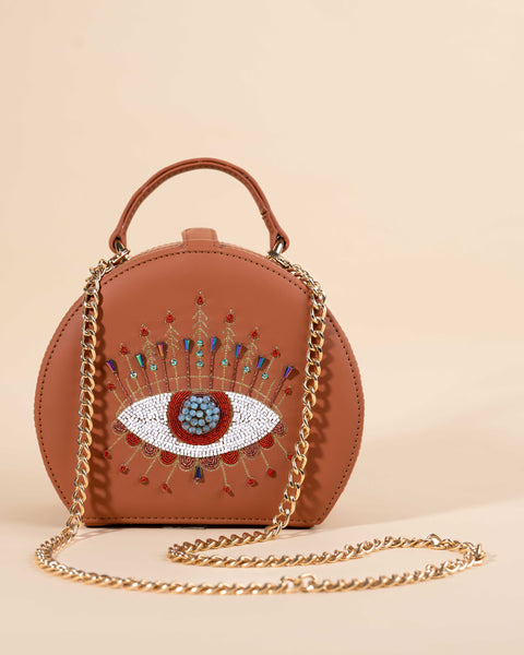 Evil eye sling bag with blue crystals, orange dabka, rose gold nakshi, and sea green sequins