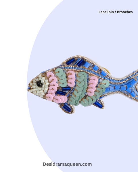 Beaded fish-shaped brooch with blue, pink, and green sequins, perfect ocean-themed fashion accessory.