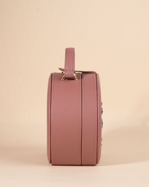 Stylish peach box sling with evil eye symbol, detailed with hand embroidery and gold fittings