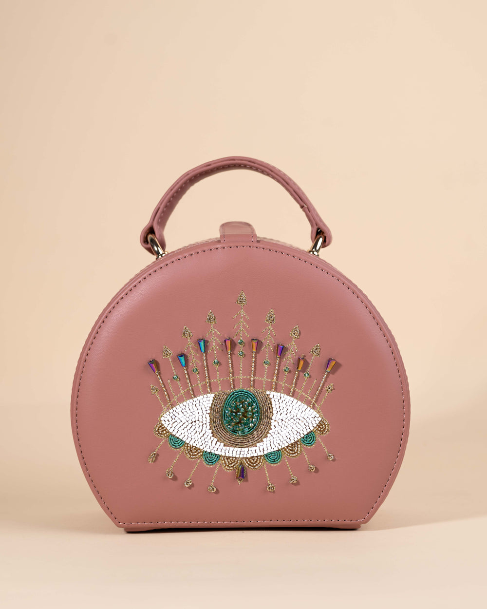 Peach box sling bag featuring evil eye motif with intricate hand embroidery, crystals, and beadwork