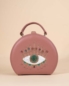 Peach box sling bag featuring evil eye motif with intricate hand embroidery, crystals, and beadwork