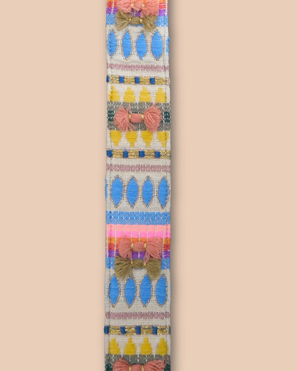 Colorful strap with geometric pattern on a beige background