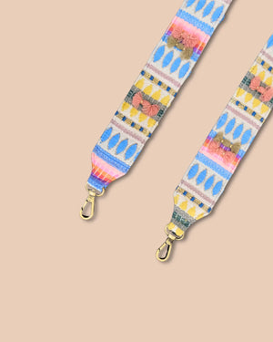 Colorful bag strap with geometric pattern on a beige background