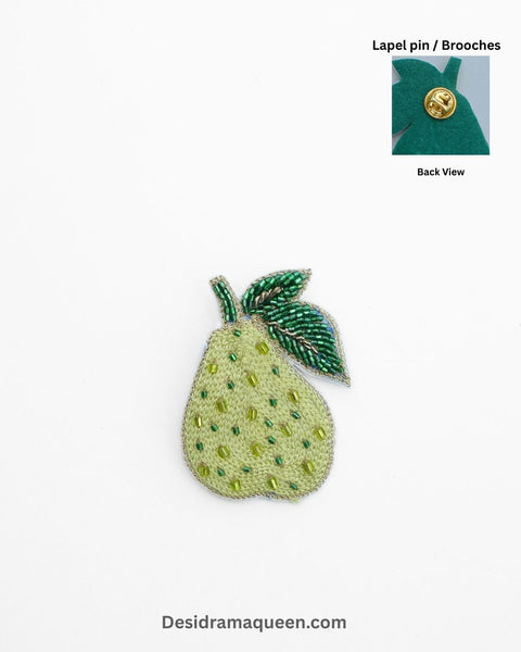 Handmade pear brooch with beaded embroidery and green leaf design, unique fruit-inspired lapel pin.