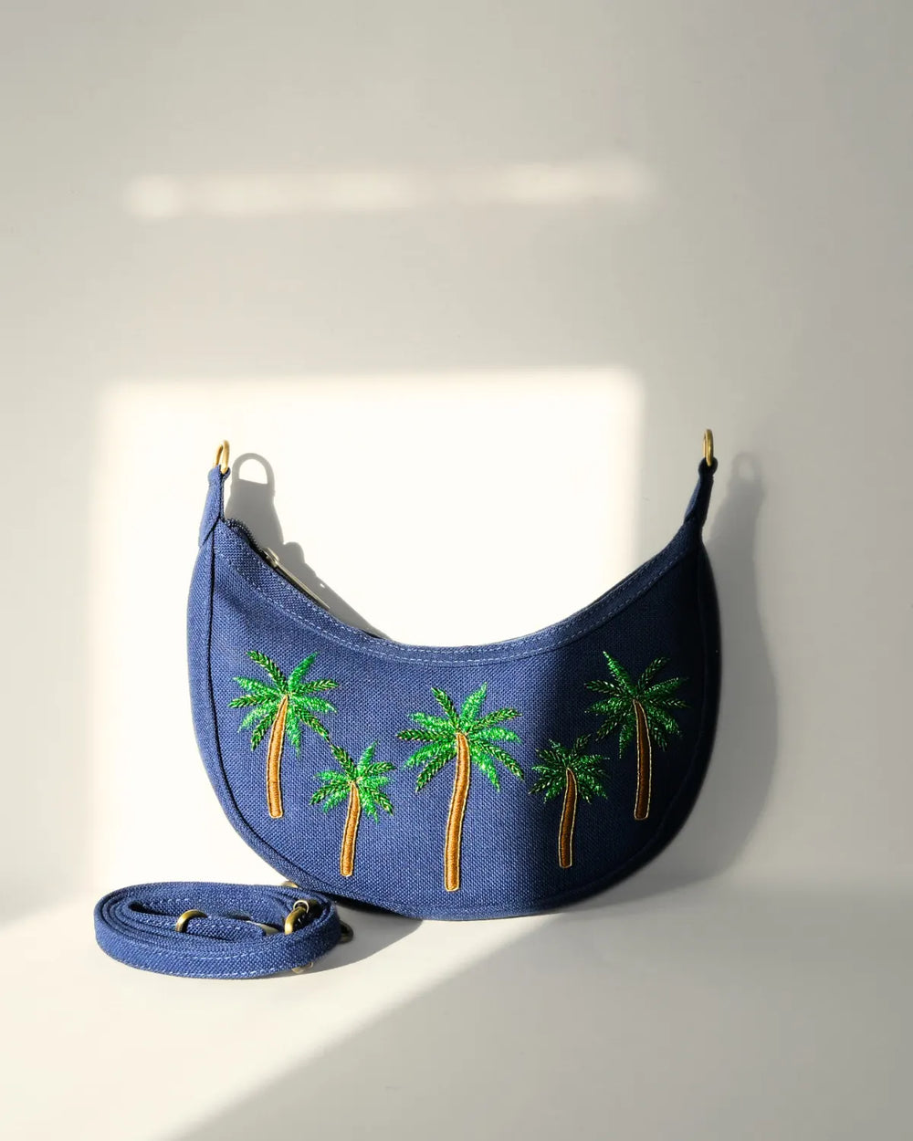 Blue bag with palm tree designs on a white background