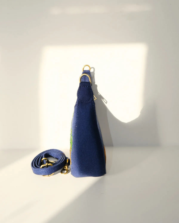 Blue handbag with a strap on a white background