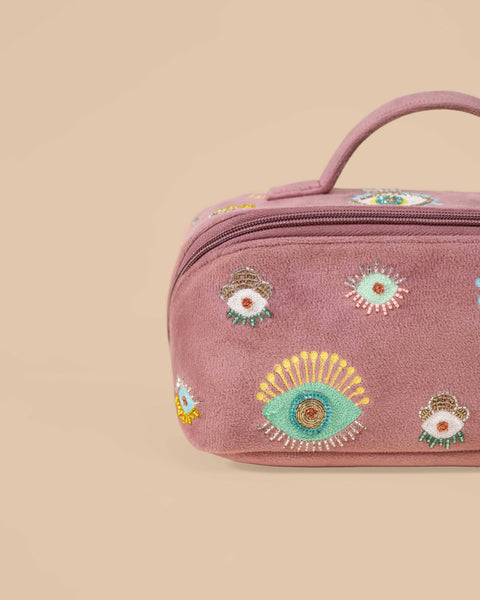 Handmade embroidered makeup pouch in dusty mauve with evil eye motifs, perfect for cosmetics and travel storage.