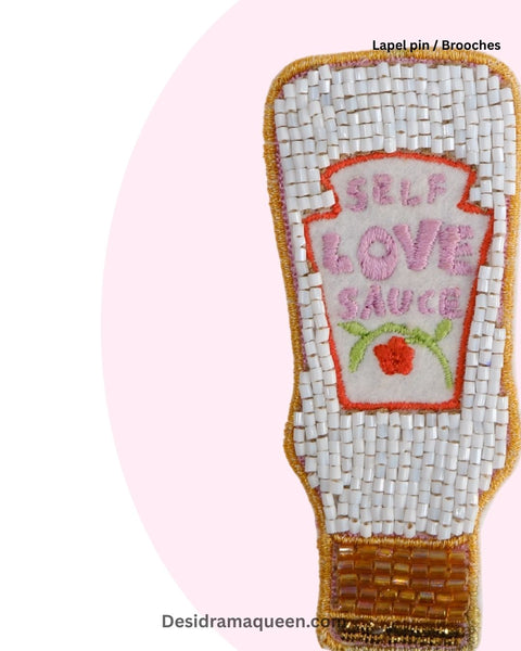 Unique handmade brooch shaped like a sauce bottle with 'Self Love Sauce' text, fun motivational lapel pin gift for women and girls.
