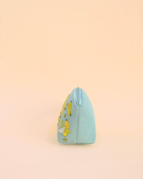 Fun pastel blue makeup pouch with banana embroidery and tassel zipper, handmade cosmetic bag for travel and storage.