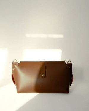 Brown leather bag on a white background