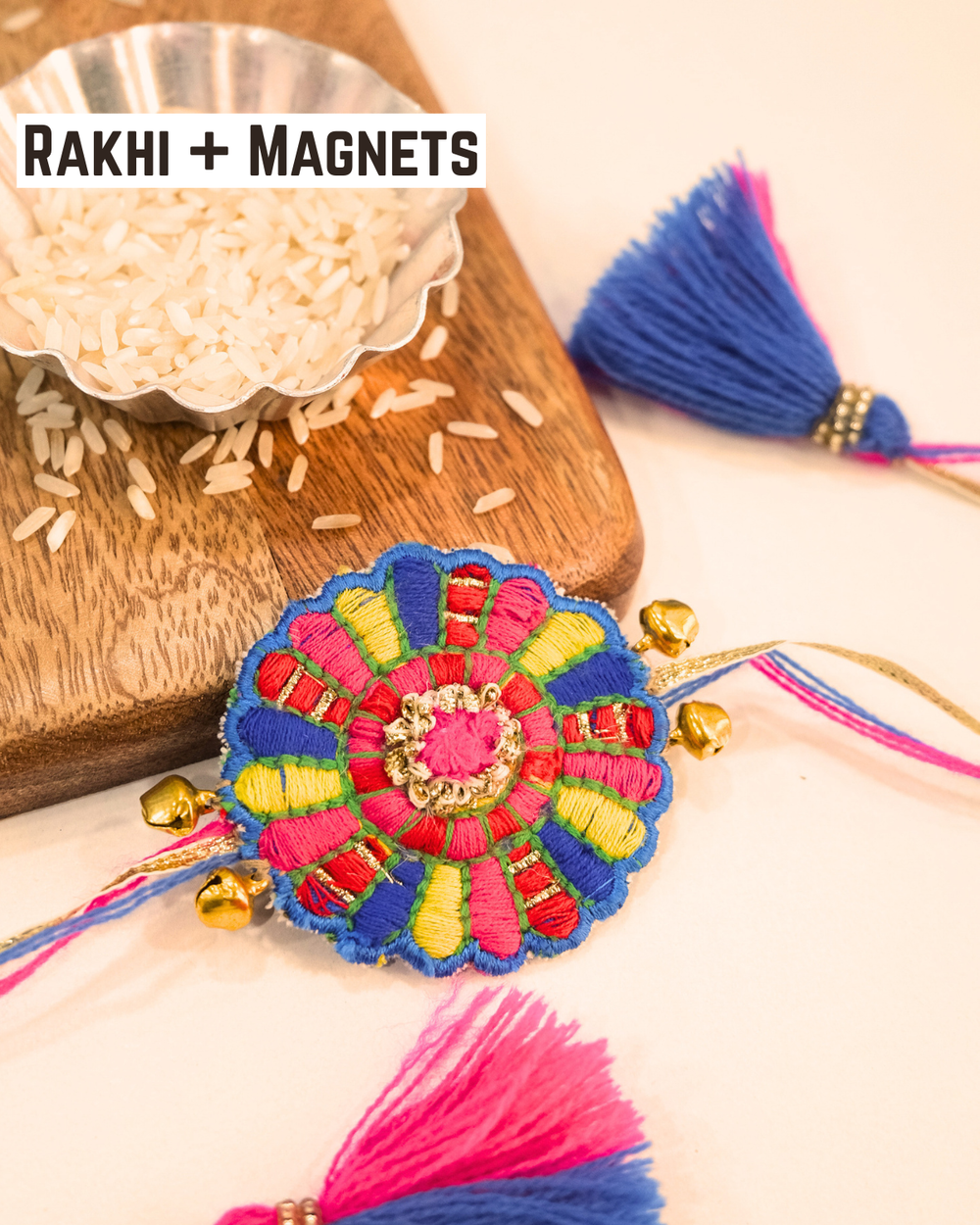 Bandhan Chakri embroidered rakhi magnet placed beside a bowl of rice, styled for a festive Raksha Bandhan celebration.