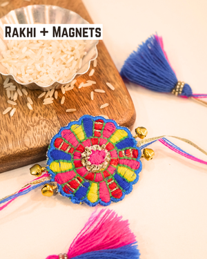 Bandhan Chakri embroidered rakhi magnet placed beside a bowl of rice, styled for a festive Raksha Bandhan celebration.