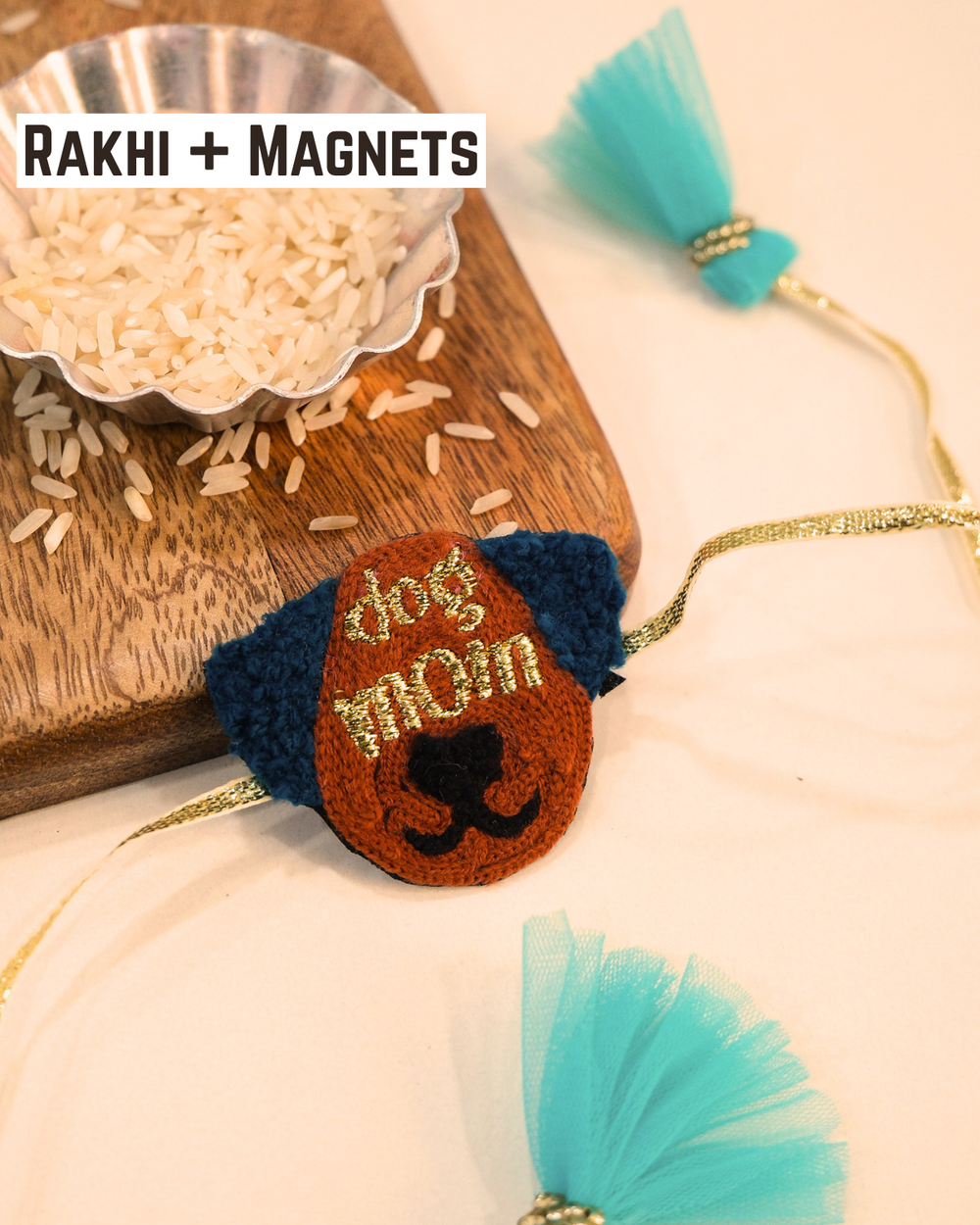 Dog Mom embroidered rakhi magnet placed beside a bowl of rice, styled for a festive Raksha Bandhan celebration.