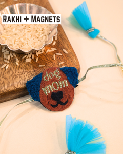Dog Mom embroidered rakhi magnet placed beside a bowl of rice, styled for a festive Raksha Bandhan celebration.
