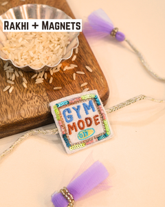 Colorful "Gym Mode On" Rakhi magnet displayed on a woden tray in rakhi set background, celebrating a fitness-loving brother.