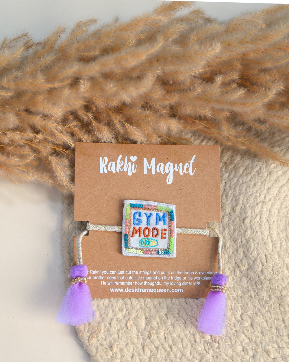 Colorful "Gym Mode On" Rakhi magnet displayed on a woden tray in rakhi set background, celebrating a fitness-loving brother.